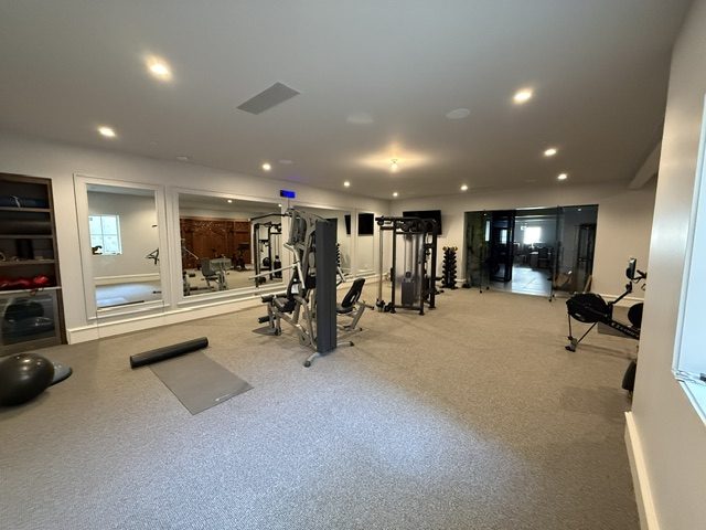 Full-length view of the training room with mirrored wall and cable machines