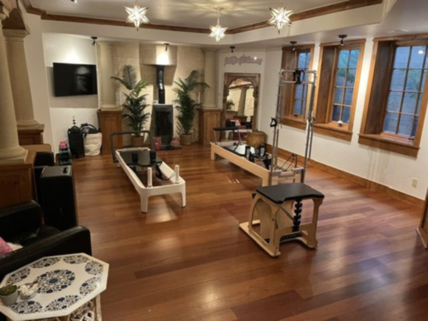 A Pilates reformer studio on dark hardwood